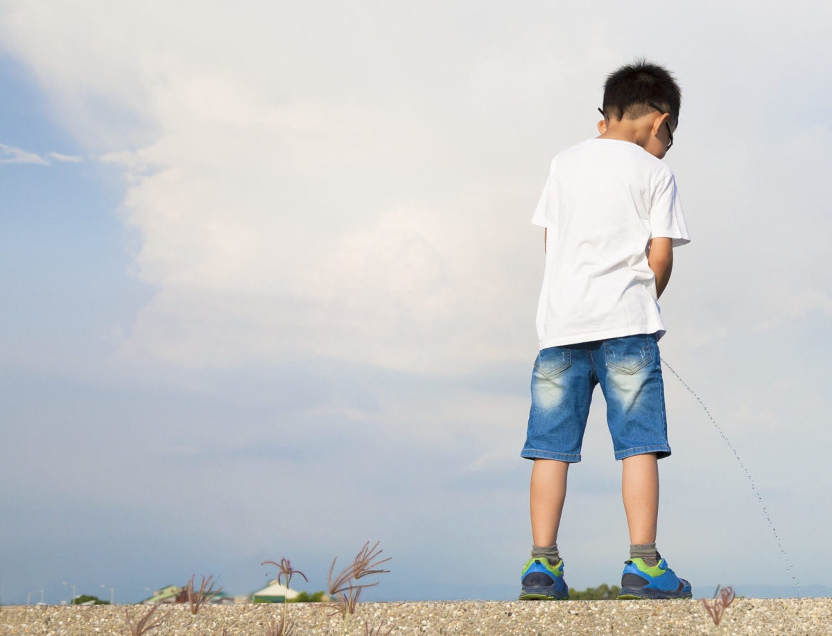 Boys and girls peeing outdoors